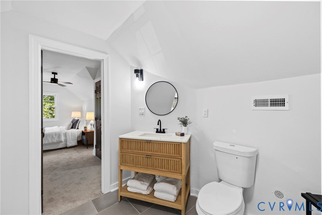 821 Fort Lee Road, North Dinwiddie, VA 23803 Modern vanity with integrated storage, circular mirror, and wall-mounted lighting