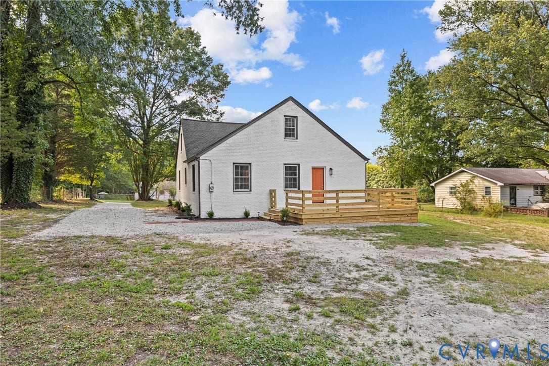 821 Fort Lee Road, North Dinwiddie, VA 23803 White exterior with dark trim windows, gabled roof, and an exterior wood deck