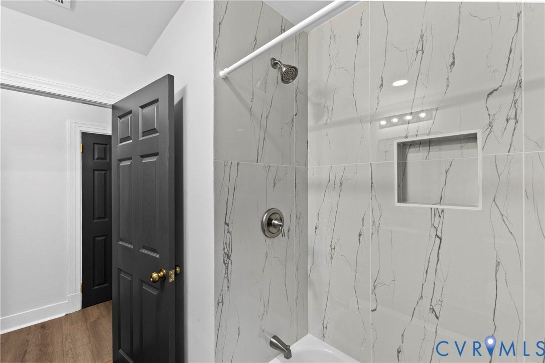 821 Fort Lee Road, North Dinwiddie, VA 23803 Bathtub with tiled surround, recessed shower niche, and ceiling-mounted lighting