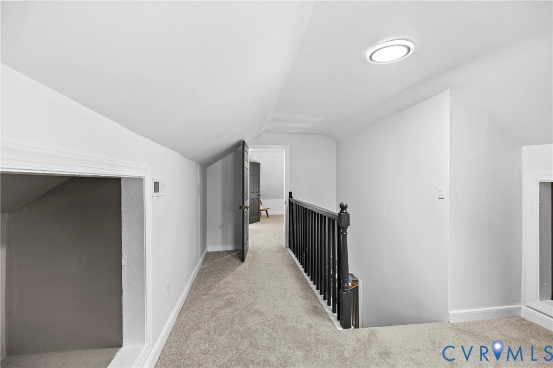 821 Fort Lee Road, North Dinwiddie, VA 23803 Carpeted hallway with white walls, black handrail, and flush-mount ceiling light