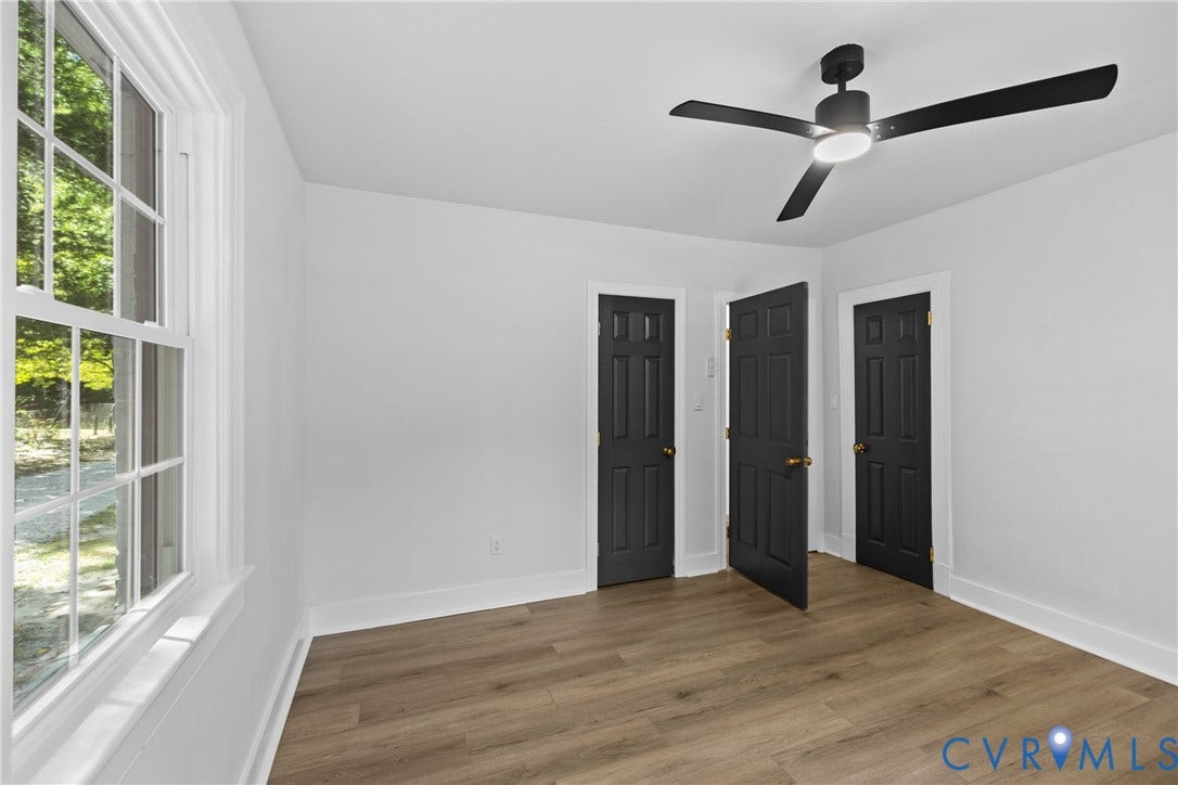 821 Fort Lee Road, North Dinwiddie, VA 23803 Bright interior with wood-finish flooring, white walls, and a multi-pane window