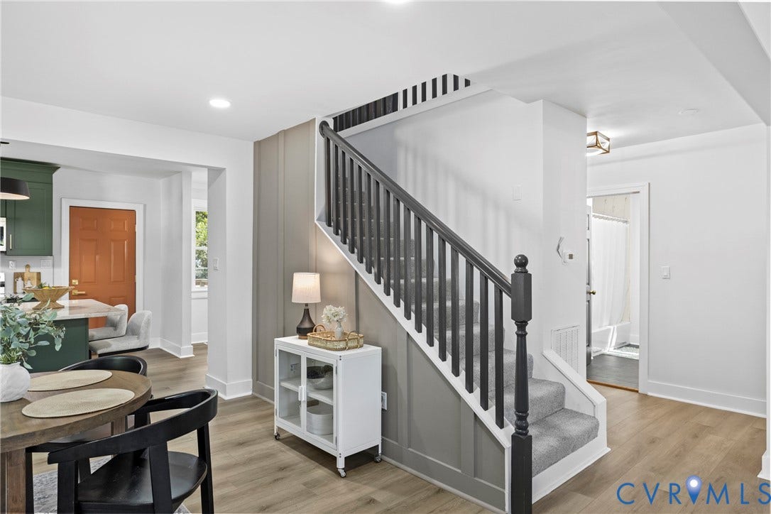 821 Fort Lee Road, North Dinwiddie, VA 23803 Gray board and batten accent wall, wood-finish flooring, recessed lighting, carpeted staircase with dark wood balusters, and a solid orange door