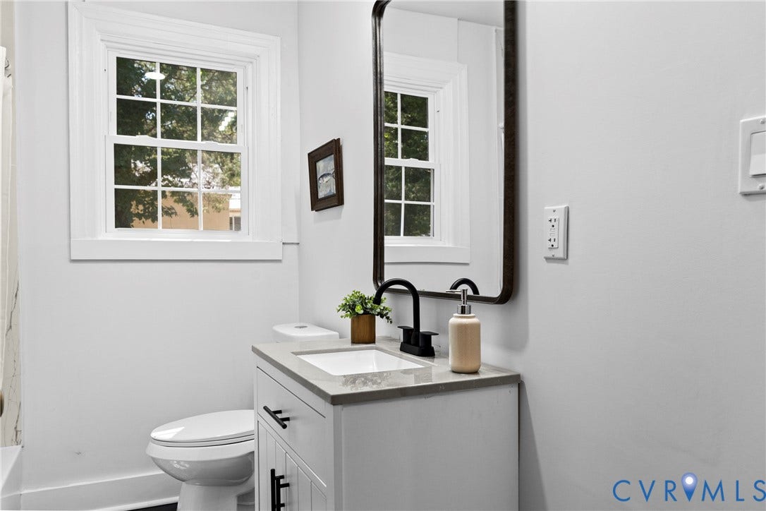 821 Fort Lee Road, North Dinwiddie, VA 23803 White vanity with a neutral countertop, dark hardware, and a black faucet