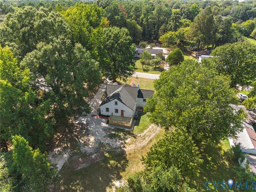 821 Fort Lee Road, North Dinwiddie, VA 23803 White exterior with a dark roof, featuring a red entry door and a wood-tone deck