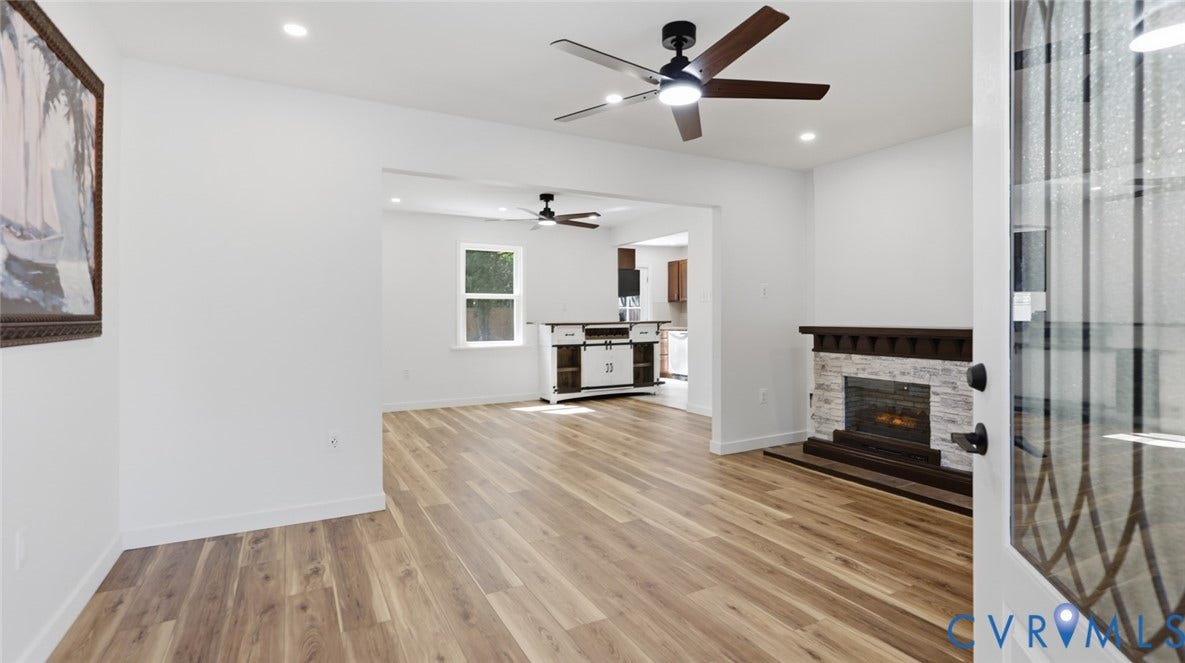 Wood-finish flooring, recessed lighting, and ceiling fan with integrated lighting