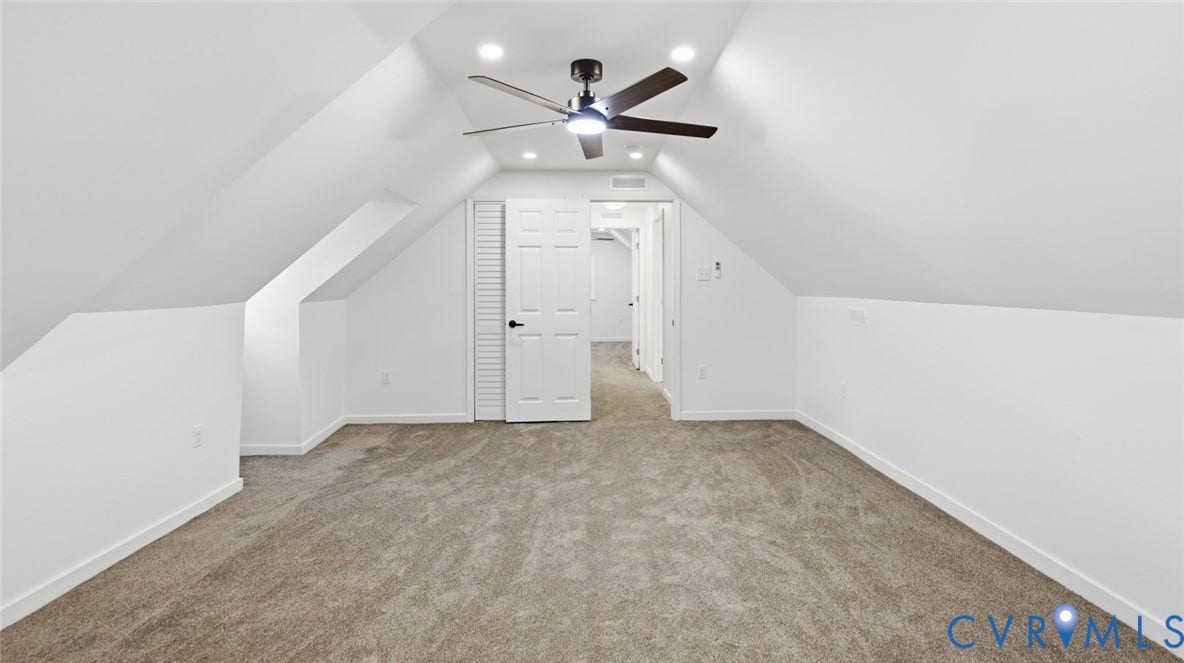Vaulted ceilings, recessed lighting, ceiling fan, carpeted flooring, and a six-panel interior door