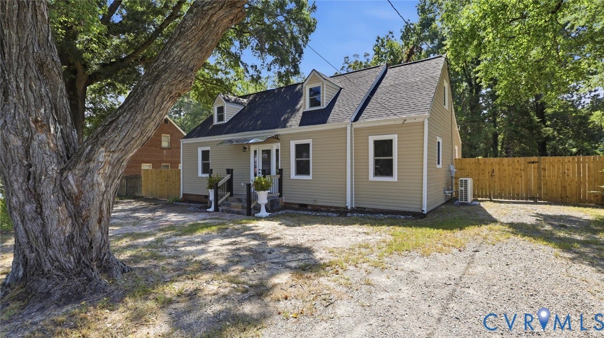 Siding exterior with dormer windows and a gabled roofline