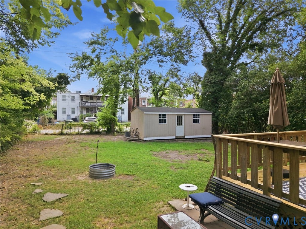 3427 W Franklin Street, Museum District, Richmond, VA 23221 Expansive grassy yard with a wooden privacy deck, a detached storage shed, and mature trees