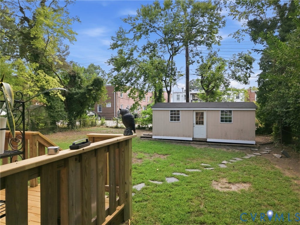 3427 W Franklin Street, Museum District, Richmond, VA 23221 Expansive backyard featuring a storage shed with multiple windows, a wood deck, and a stone-paver path