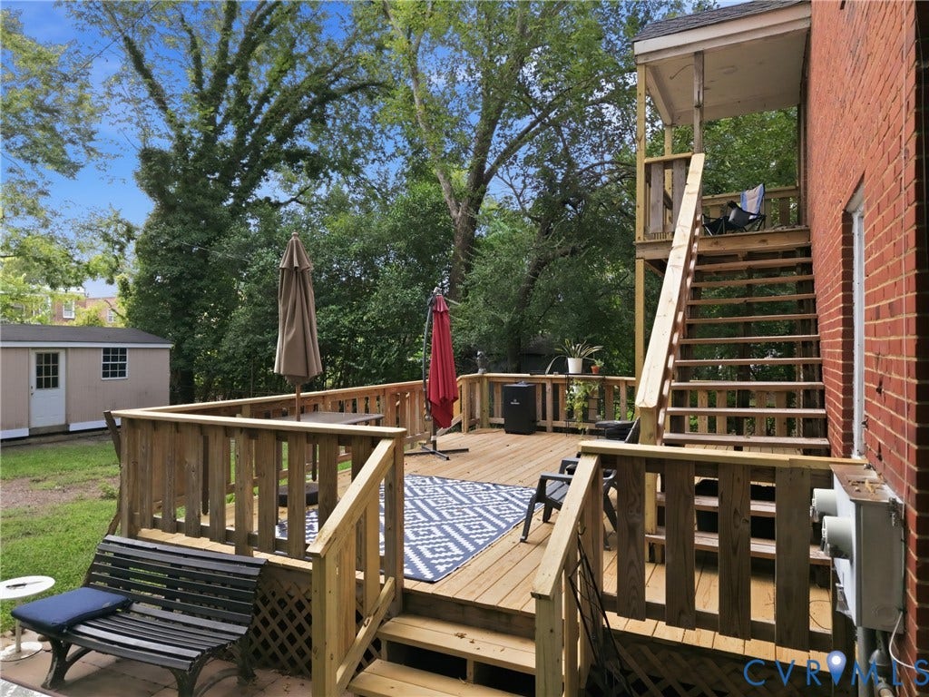 3427 W Franklin Street, Museum District, Richmond, VA 23221 Multi-level wood deck with wood railings, exterior brick wall, and a separate storage shed