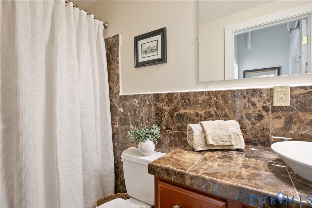 212 W Franklin Street, #U204, Monroe Ward, Richmond, VA 23220 Bathroom featuring a vessel sink and marbled tile