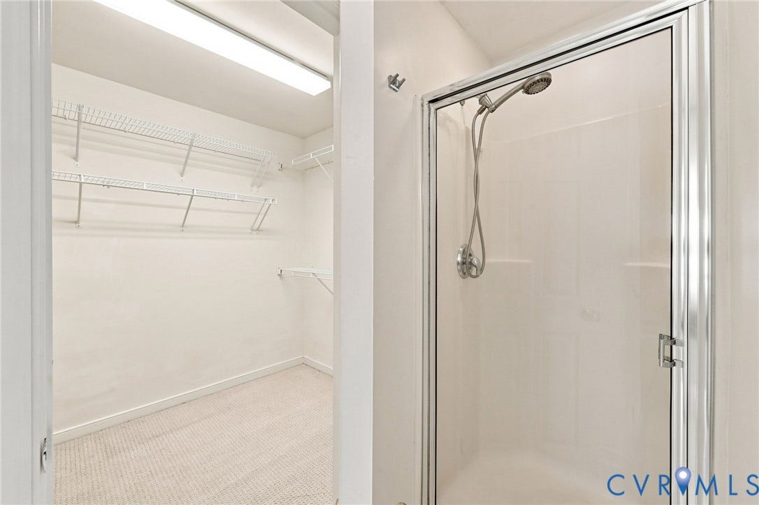 Walk-in closet with wire shelving and recessed lighting