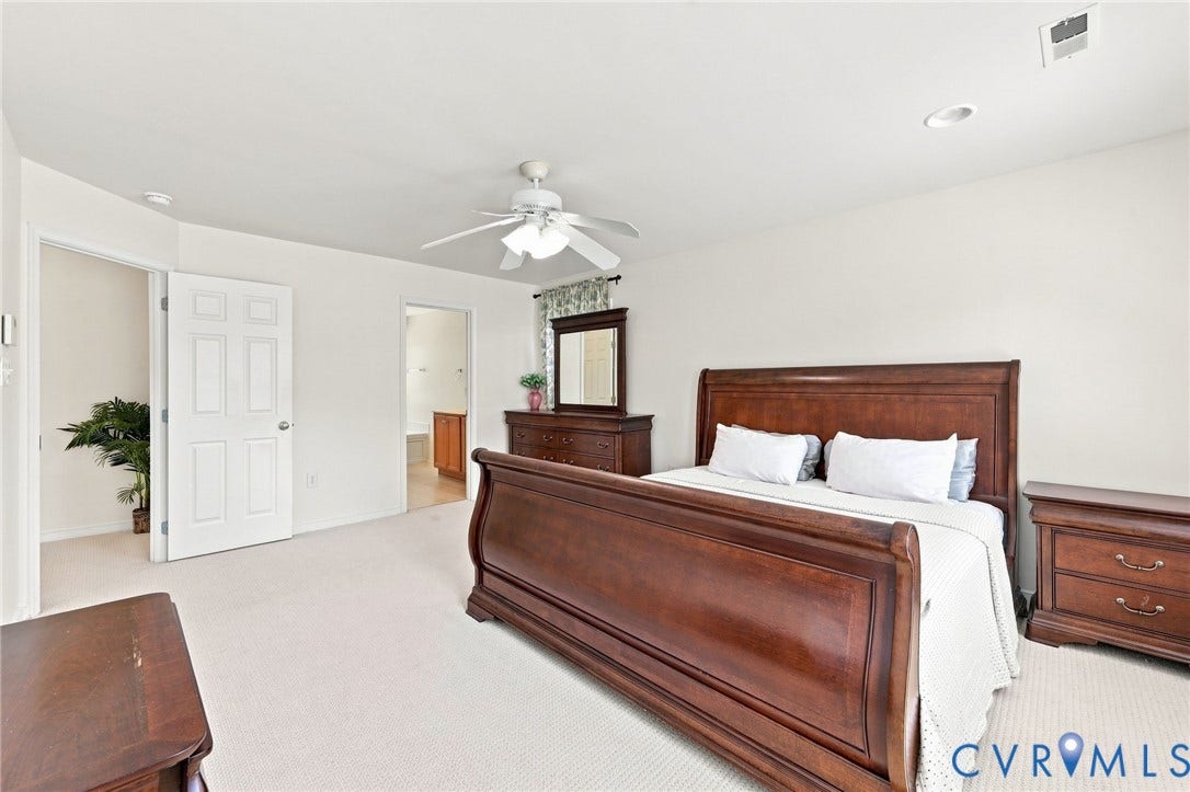Neutral wall tones with recessed lighting, a ceiling fan, and soft carpeting