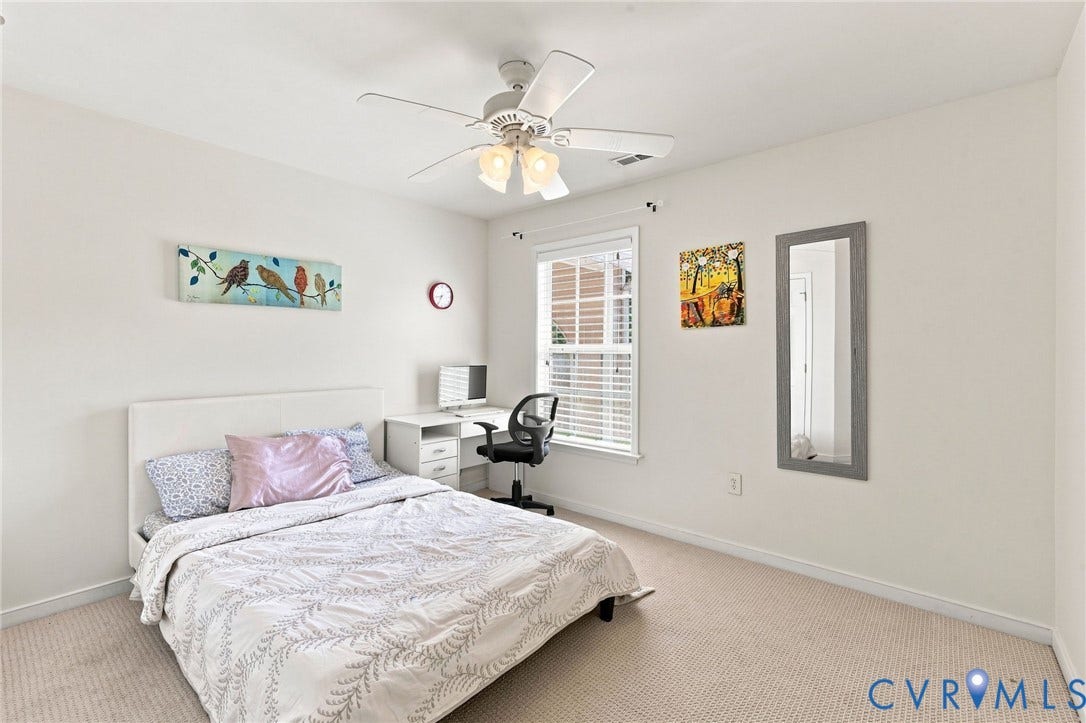 Recessed window with white blinds, neutral wall-to-wall carpeting, and a ceiling fan with integrated lighting