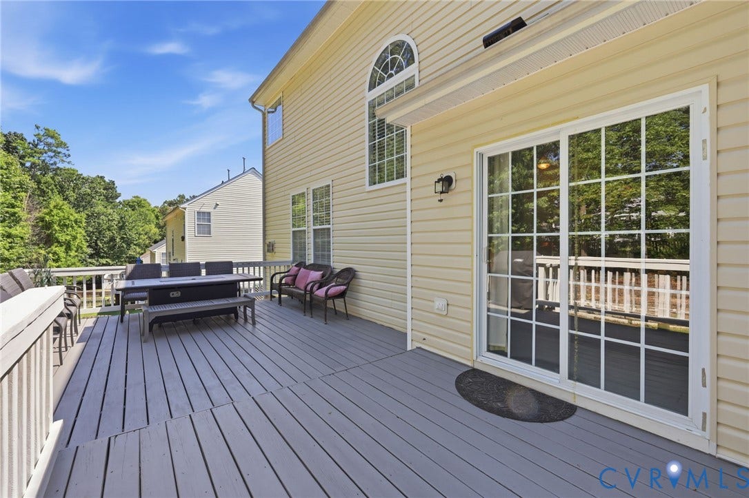 Expansive outdoor deck with painted wood flooring and white railing