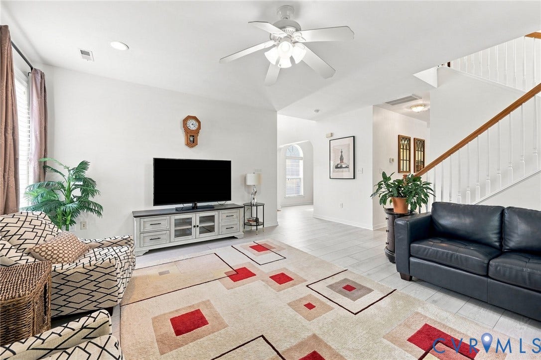 Recessed lighting, ceiling fan, wood-finish flooring, staircase with wood handrail, and arched doorway