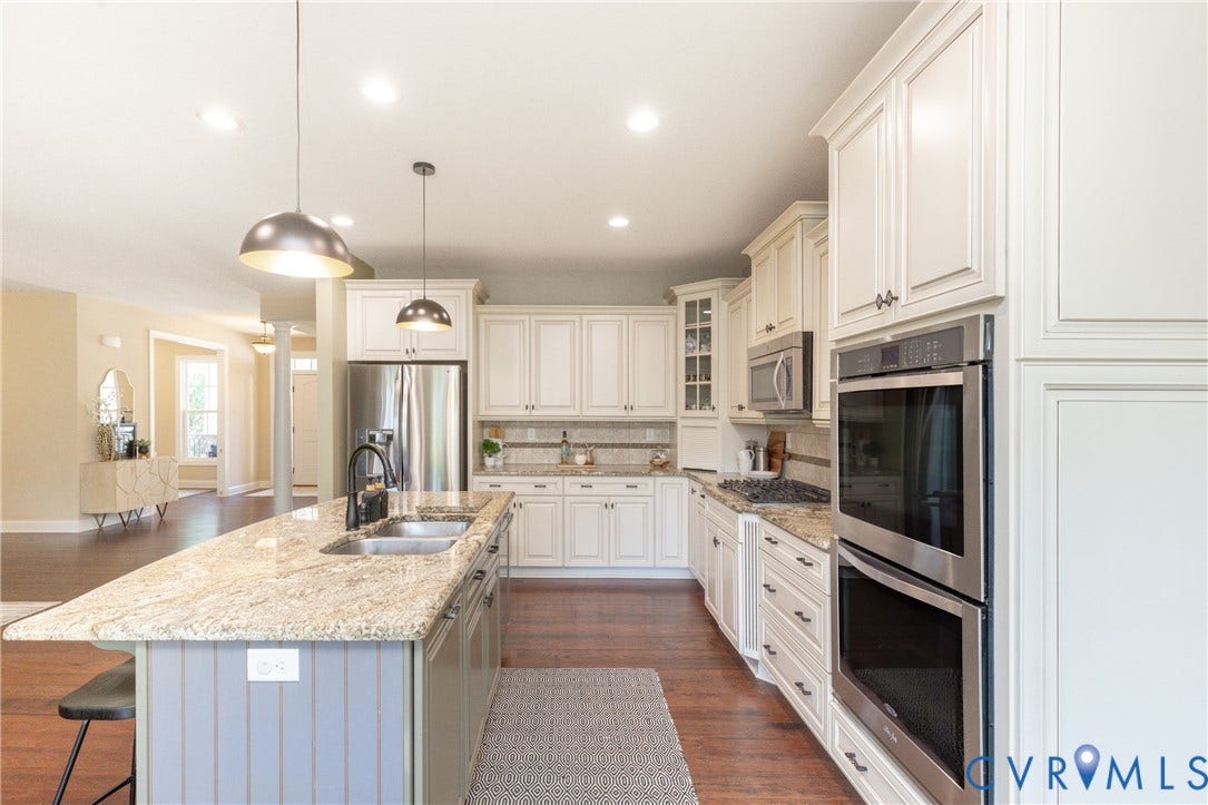 14806 Creekbrook Terrace, Brookcreek Estates, Midlothian, VA 23113 Kitchen featuring a large island with sink, ample cabinetry, granite countertops, stainless steel appliances, and wood-finish flooring