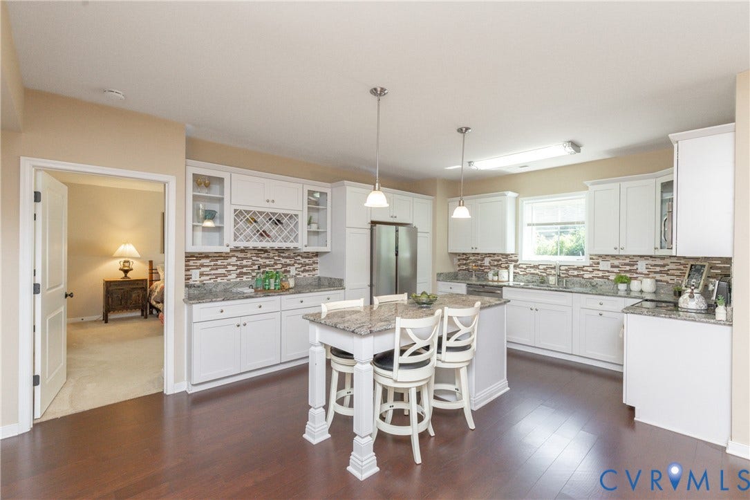 14806 Creekbrook Terrace, Brookcreek Estates, Midlothian, VA 23113 White cabinetry, stainless steel appliances, granite countertops, decorative tile backsplash, and wood-finish flooring