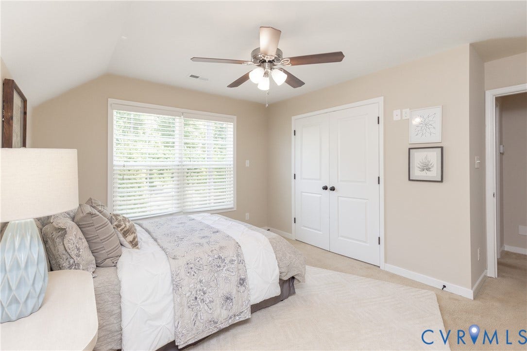 14806 Creekbrook Terrace, Brookcreek Estates, Midlothian, VA 23113 Vaulted ceiling, ceiling fan with integrated lighting, window with blinds, white bi-fold closet doors, and neutral carpeting