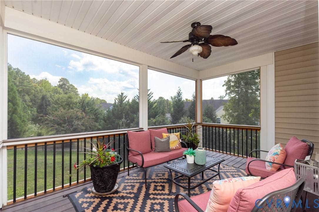 14806 Creekbrook Terrace, Brookcreek Estates, Midlothian, VA 23113 Screened porch featuring a ceiling fan with integrated lighting, wood-finish flooring, and black metal railings with a wood-tone top rail
