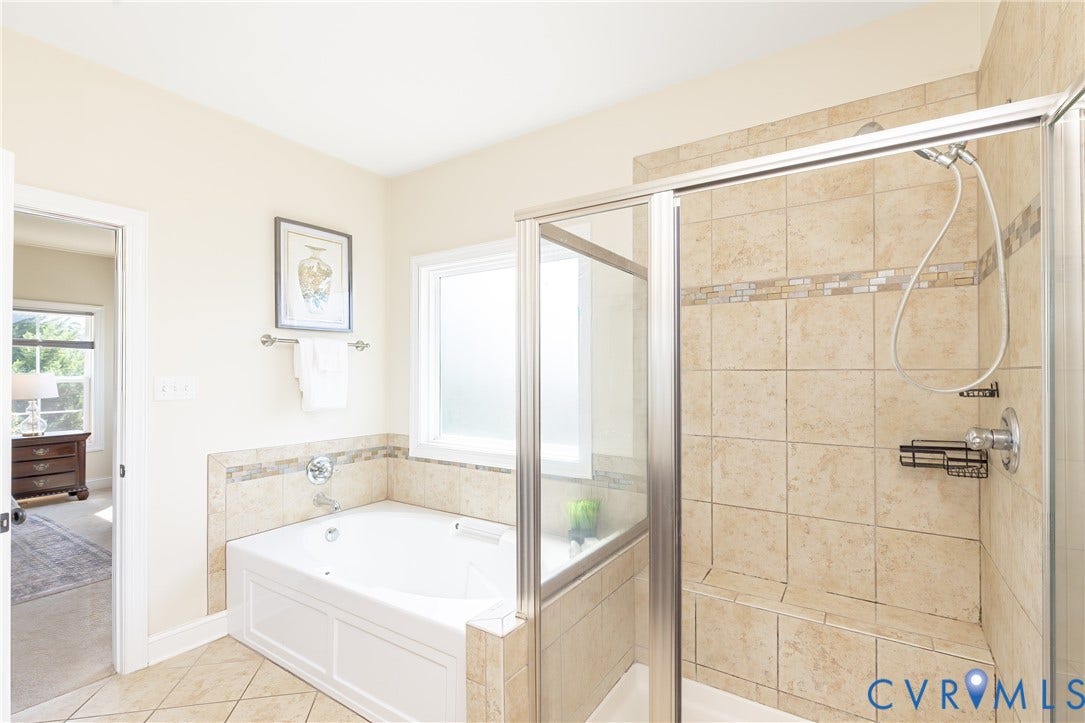 14806 Creekbrook Terrace, Brookcreek Estates, Midlothian, VA 23113 Tiled bathroom featuring a built-in jetted tub, separate glass-enclosed shower with tiled walls and a built-in bench, and a privacy window