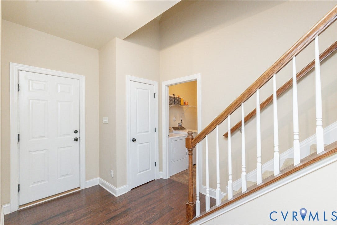 14806 Creekbrook Terrace, Brookcreek Estates, Midlothian, VA 23113 Hardwood flooring, painted interior walls, white paneled doors, hardwood staircase with white balusters, and a compact laundry area