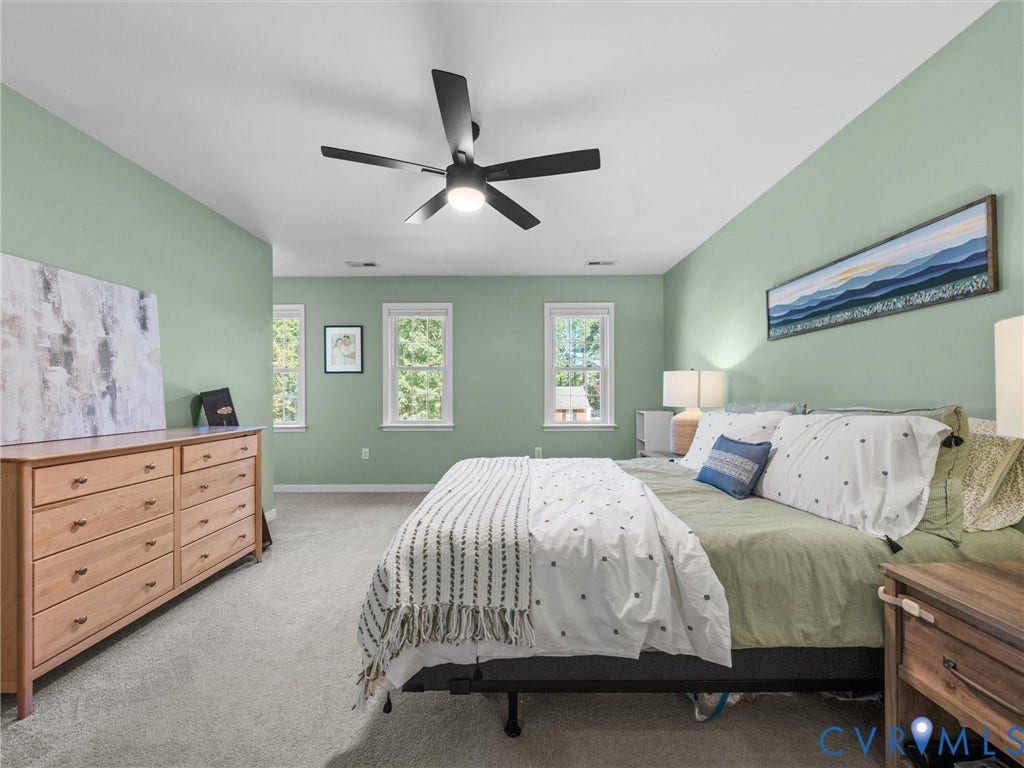 Recessed lighting, ceiling fan with integrated light, multiple windows, and light-toned carpeting