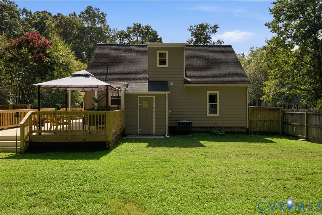 13602 Velvet Antler Place, Midlothian, VA 23112 Expansive backyard featuring a manicured lawn, a multi-level wood deck, and a privacy fence
