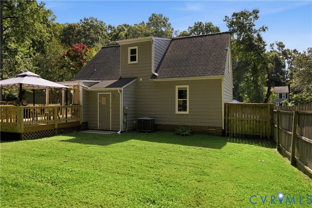 13602 Velvet Antler Place, Midlothian, VA 23112 Expansive backyard featuring a manicured lawn, a wooden deck, and a privacy fence