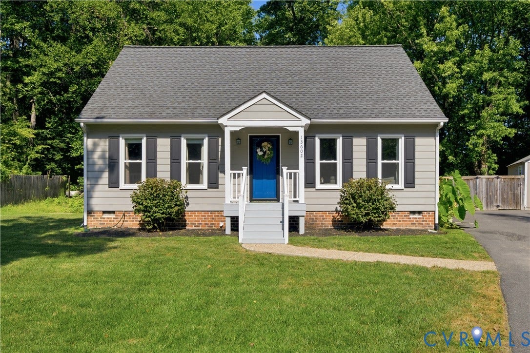 13602 Velvet Antler Place, Midlothian, VA 23112 Exterior featuring light gray siding, dark gray shutters, a vibrant blue front door, a front porch with white railings, and a neatly manicured lawn