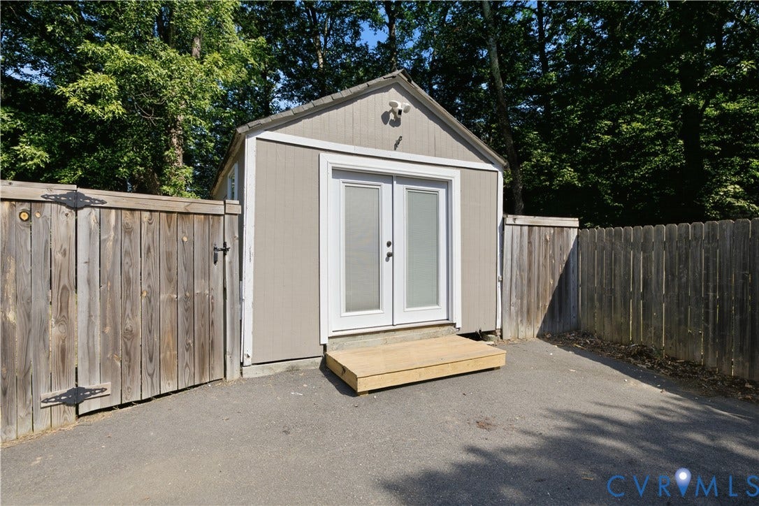 13602 Velvet Antler Place, Midlothian, VA 23112 Shed with double glass-panel doors, exterior security camera, and wood step