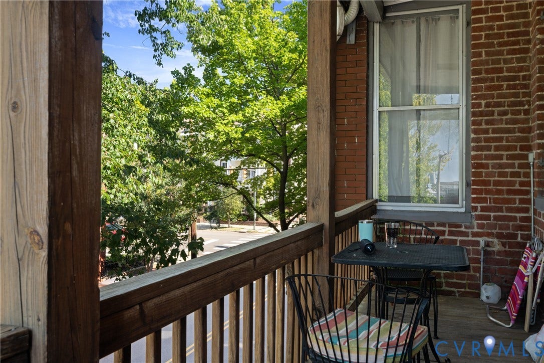 1527 Grove Avenue, #3, Richmond, VA 23220 Exterior balcony featuring brick siding, wood-finish railings, and a double-hung window