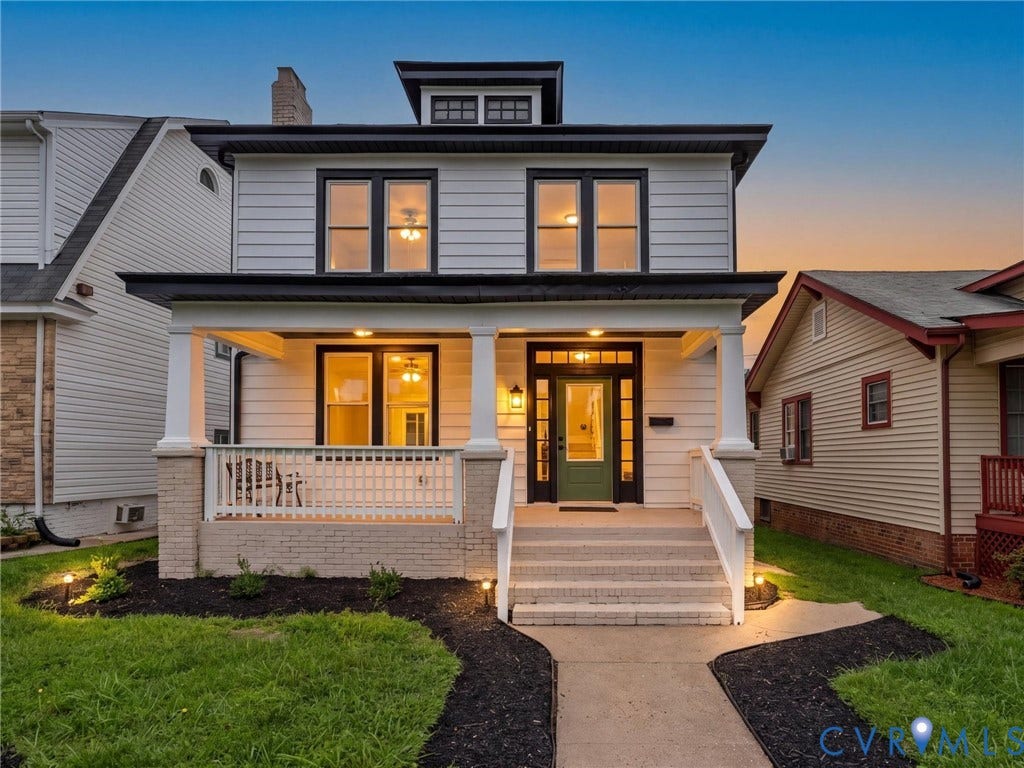 2623 Northumberland Avenue, Richmond, VA 23220 Traditional-style home featuring a covered front porch, white siding, black-trimmed windows, a prominent dormer, and a green entry door