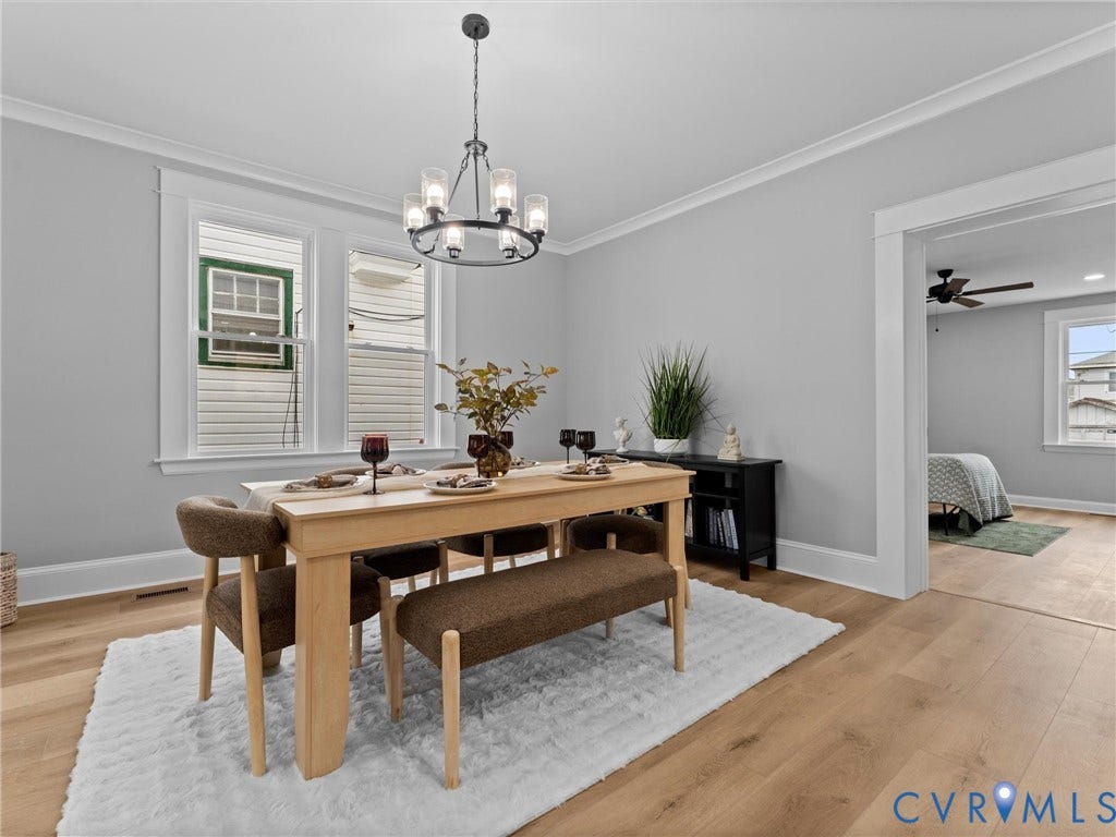 2623 Northumberland Avenue, Richmond, VA 23220 Light-toned wood-finish flooring, crisp white crown molding, and a modern chandelier with a matte black finish