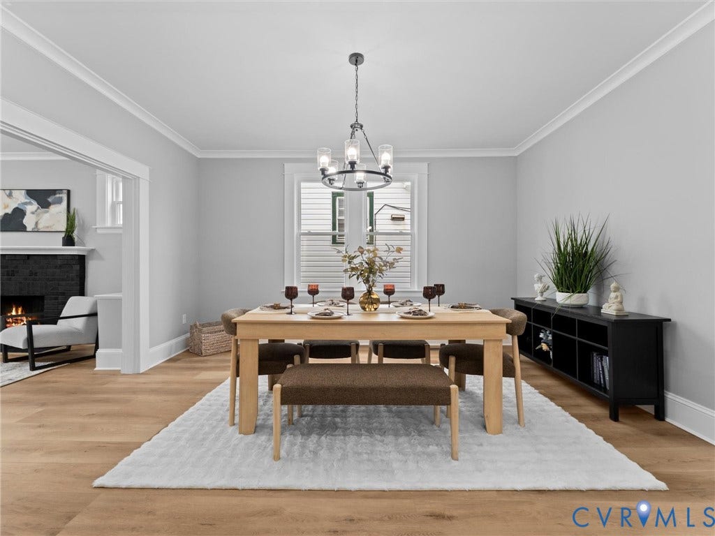 2623 Northumberland Avenue, Richmond, VA 23220 Crown molding, wood-finish flooring, and a multi-light chandelier enhance this dining space