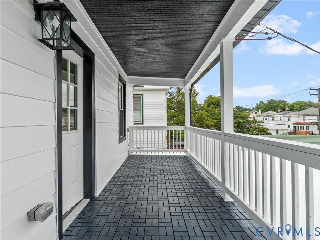 2623 Northumberland Avenue, Richmond, VA 23220 Covered porch featuring white siding, black ceiling, white railing, and dark tile flooring