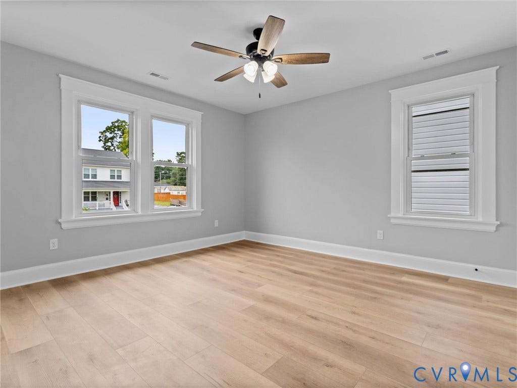 2623 Northumberland Avenue, Richmond, VA 23220 Light gray walls, wood-finish flooring, white window trim, and a ceiling fan with integrated lighting