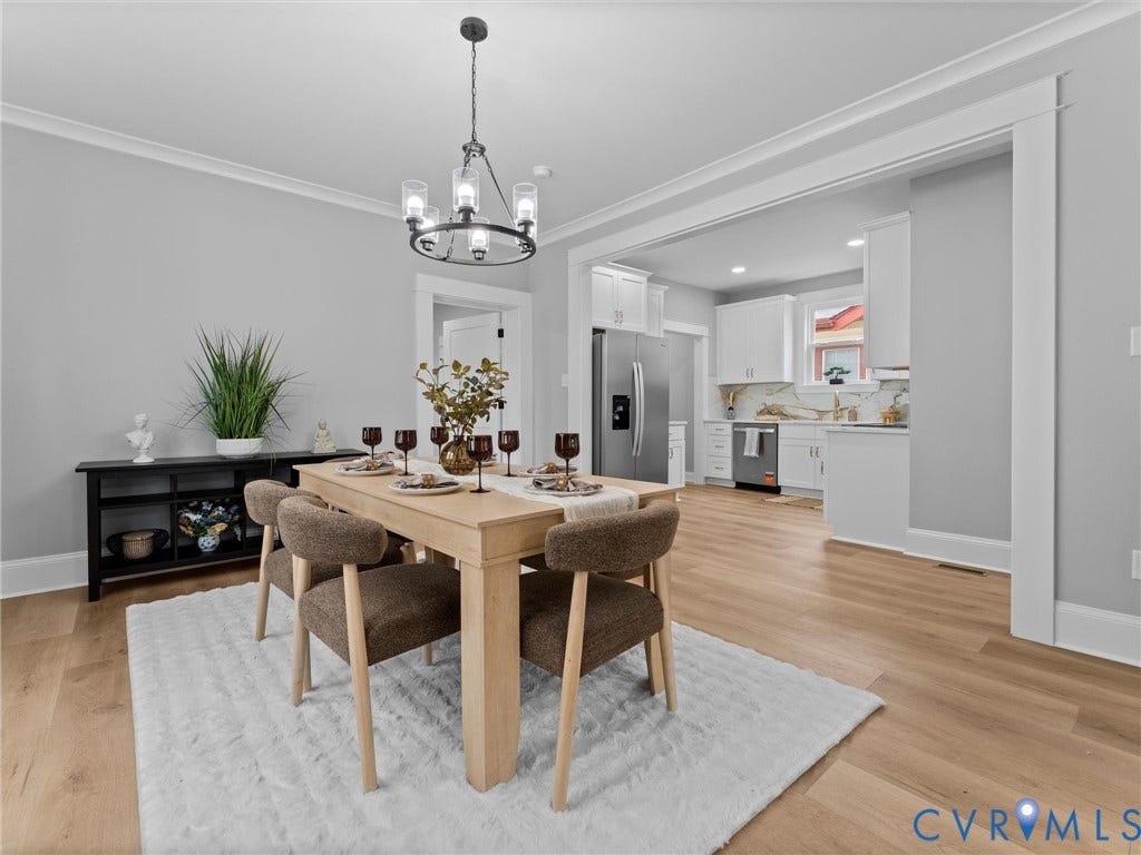 2623 Northumberland Avenue, Richmond, VA 23220 Open-concept dining area featuring wood-finish flooring, a contemporary chandelier, and crown molding
