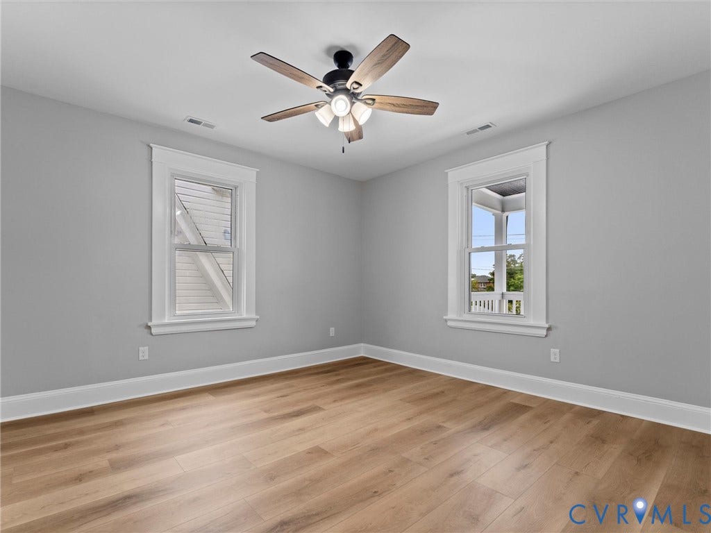 2623 Northumberland Avenue, Richmond, VA 23220 Wood-finish flooring, white window trim, and a ceiling fan with light fixture