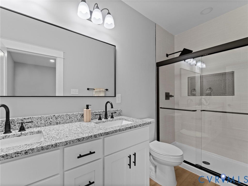 2623 Northumberland Avenue, Richmond, VA 23220 Dual vanity with granite-style countertop, undermount sinks, and matte black fixtures