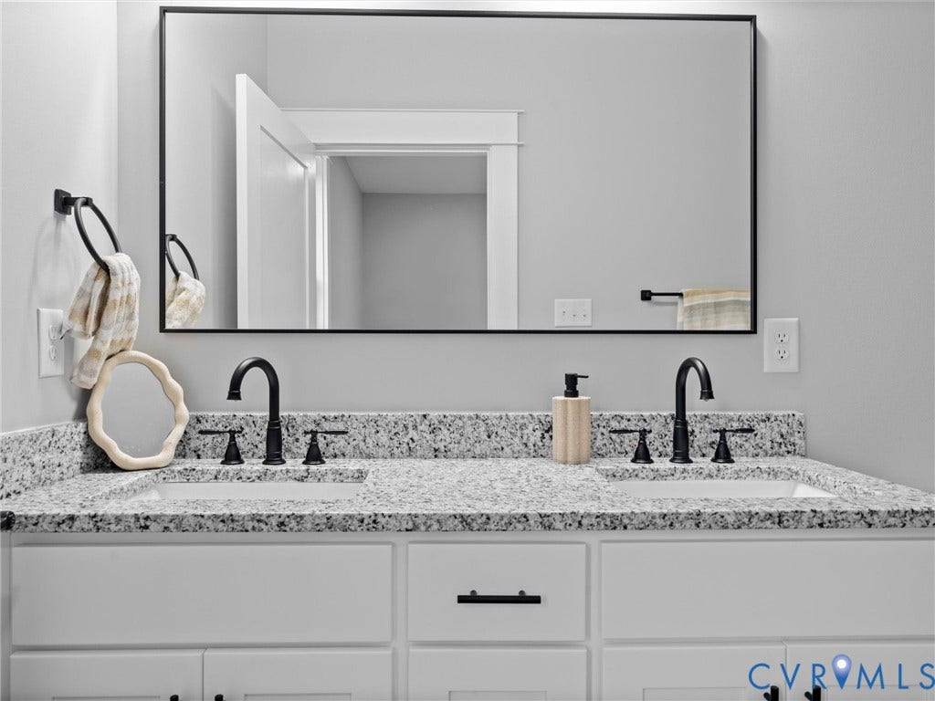 2623 Northumberland Avenue, Richmond, VA 23220 Dual vanity with a speckled countertop, integrated sinks, and matte black fixtures