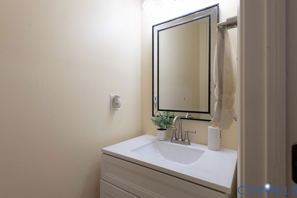 14107 Beachmere Road, Stoney Glen South, Chester, VA 23831 White vanity with shaker-style door, integrated sink, and brushed nickel faucet