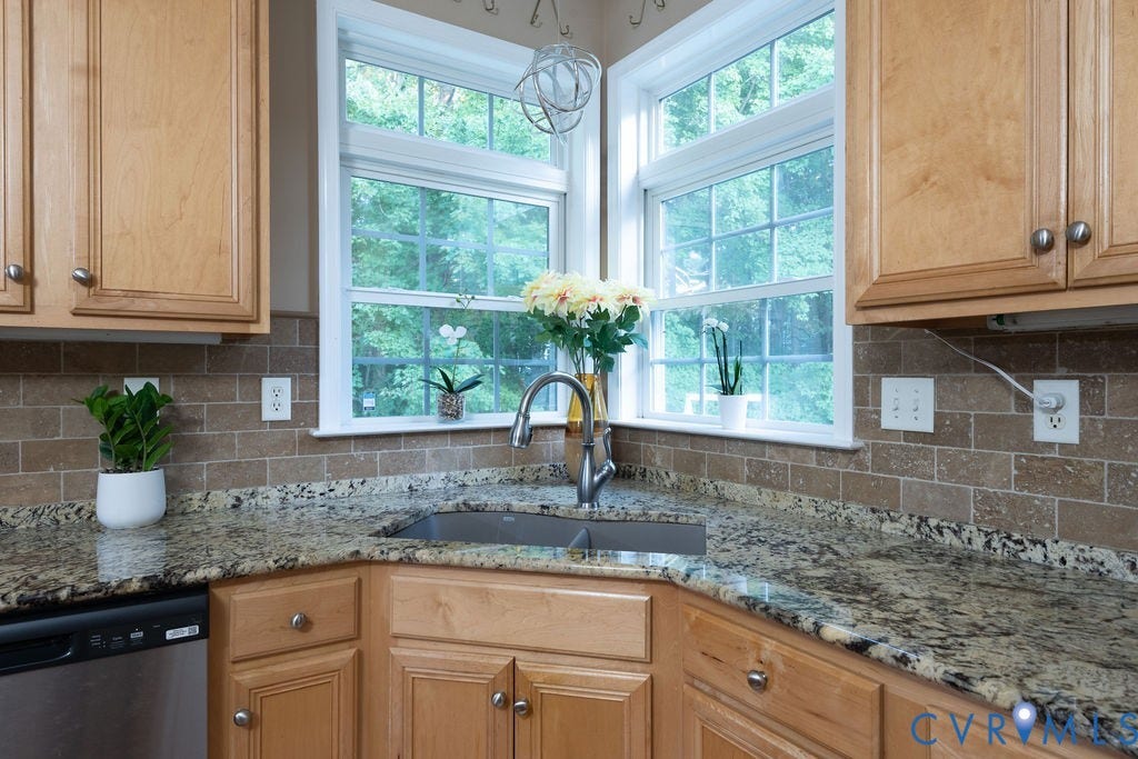 14107 Beachmere Road, Stoney Glen South, Chester, VA 23831 Corner kitchen sink with a gooseneck faucet, light wood-finish cabinetry, granite countertops, and a subway tile backsplash