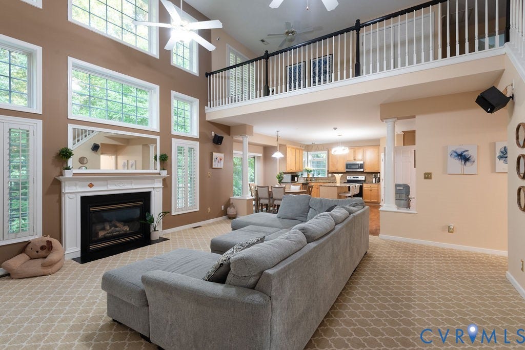14107 Beachmere Road, Stoney Glen South, Chester, VA 23831 Two-story living area with a gas fireplace, decorative mantel, and extensive window array