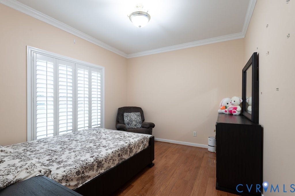 14107 Beachmere Road, Stoney Glen South, Chester, VA 23831 Hardwood flooring, crown molding, plantation shutters, and a semi-flush mount ceiling light