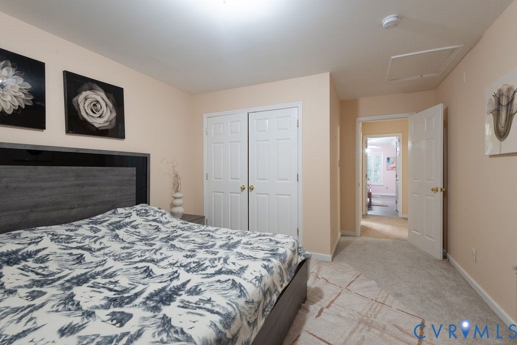 14107 Beachmere Road, Stoney Glen South, Chester, VA 23831 Hardwood-look headboard, dual bi-fold closet doors, and light-colored wall paint