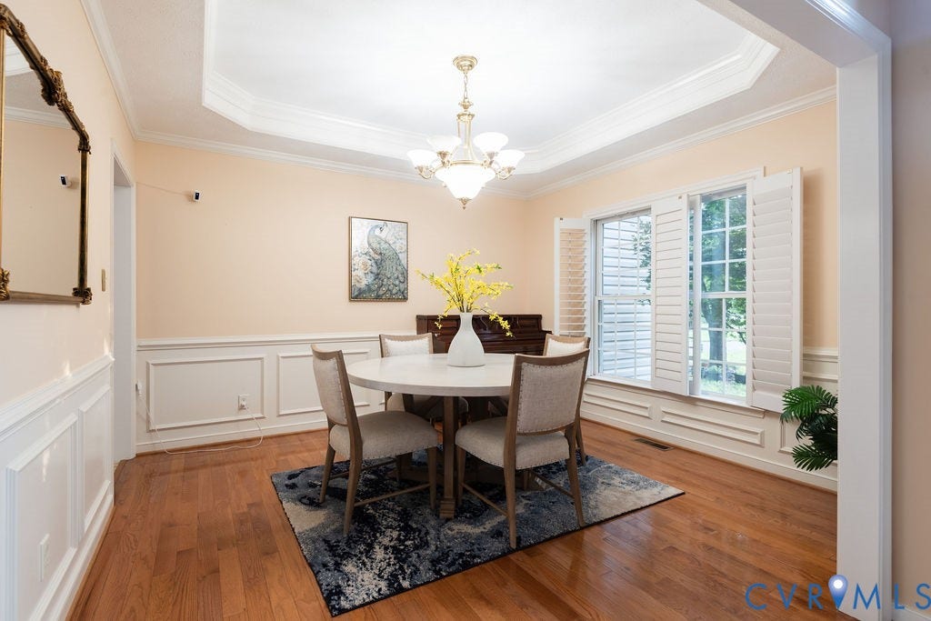 14107 Beachmere Road, Stoney Glen South, Chester, VA 23831 Tray ceiling, hardwood flooring, wainscoting, plantation shutters, and a chandelier