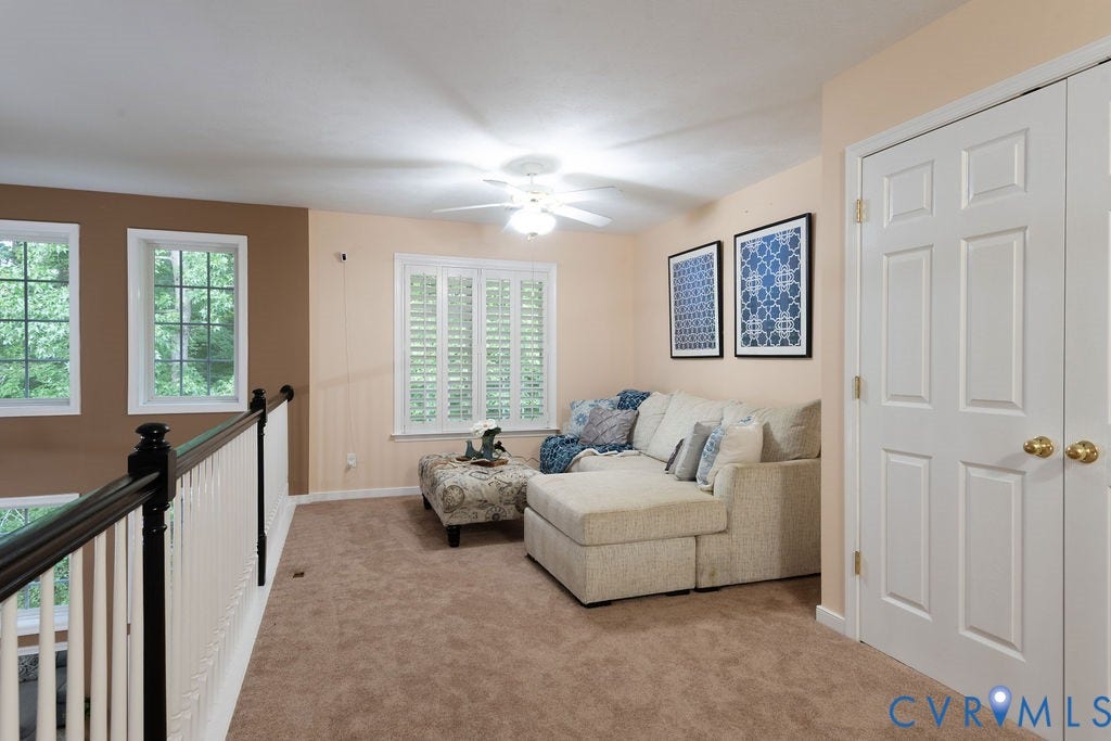 14107 Beachmere Road, Stoney Glen South, Chester, VA 23831 Carpeted living space featuring multiple windows, a ceiling fan, and white paneled doors