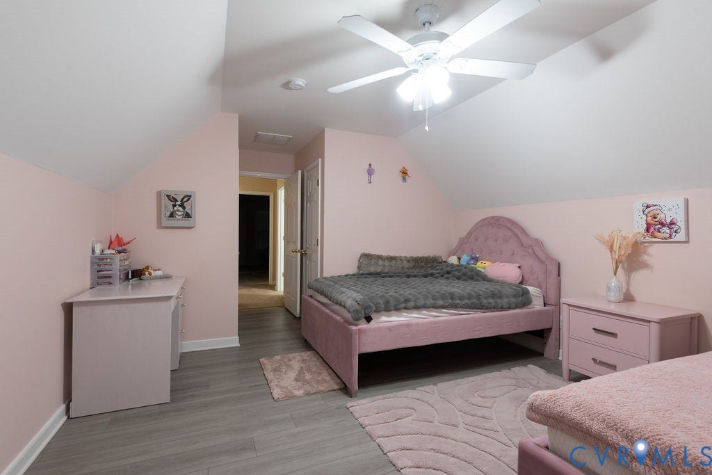 14107 Beachmere Road, Stoney Glen South, Chester, VA 23831 Sloped ceiling room featuring wood-finish flooring, a ceiling fan with integrated lighting, and a white interior door