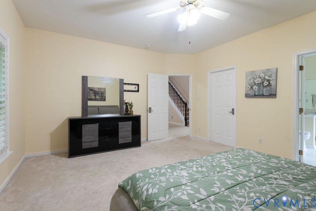 14107 Beachmere Road, Stoney Glen South, Chester, VA 23831 Carpeted room featuring a ceiling fan with light, white window shutters, and multiple entryways